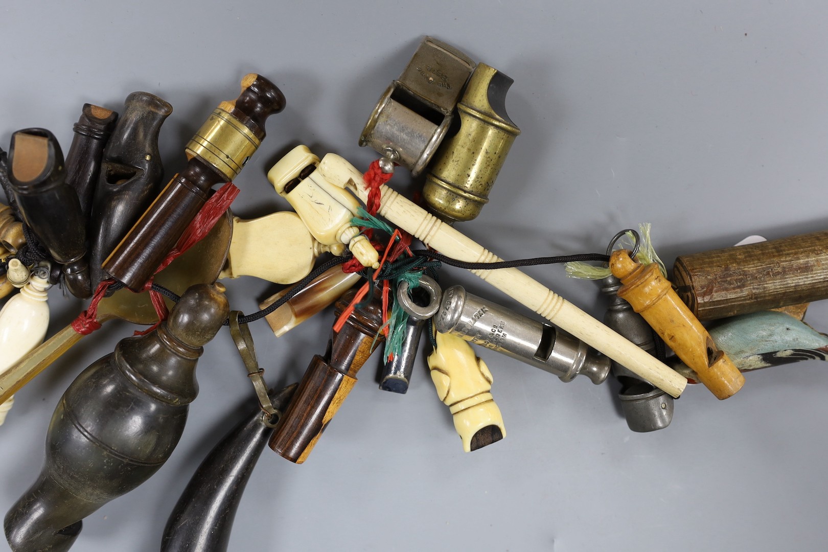 A collection of various collectable 19th century whistles, including bone, pewter, horn, ebony, brass and some ivory.